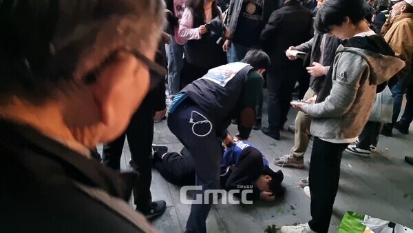 9일 오후 서울 숭례문 앞에서 열린 민주노총 주최 '전태일 열사 54주기 정신 계승 전국노동자대회·윤석열 정권 퇴진 1차 총궐기'에서 경찰과 물리적 충돌이 발생해 다수의 부상자가 발생했다.  노조 관계자가 쓰러진 참가자를 돕기 위해 달려가고 있다. (사진=굿모닝충청 설인호 기자) 