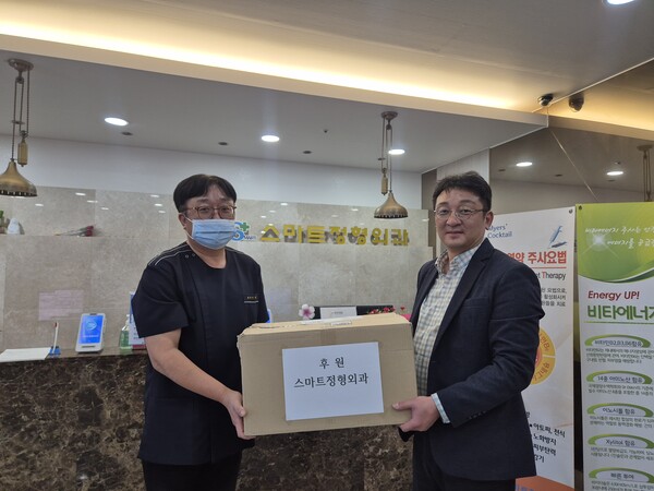 대전장애인주간보호시설협회 서구지회에 구충제를 전달하는 병원장 이창수(좌)